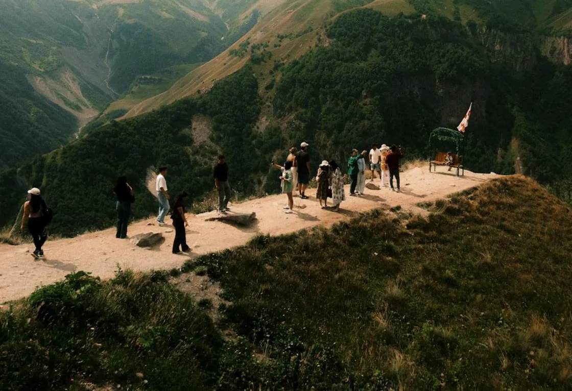 A group at a viewpoint in the Kazbegi mountains